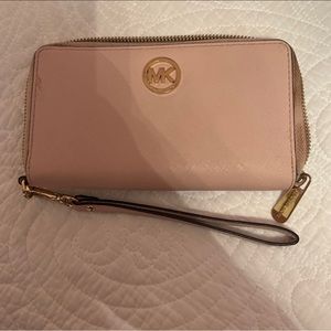 large pink Michael Kors multipurpose wallet
